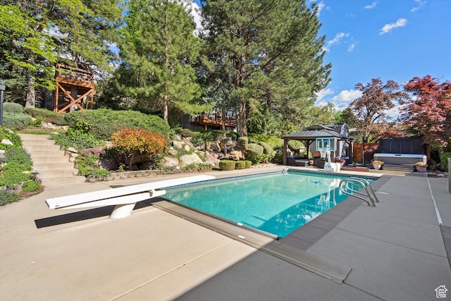 swimming pool featuring a hot tub, a gazebo, a diving board, stairway, and a patio