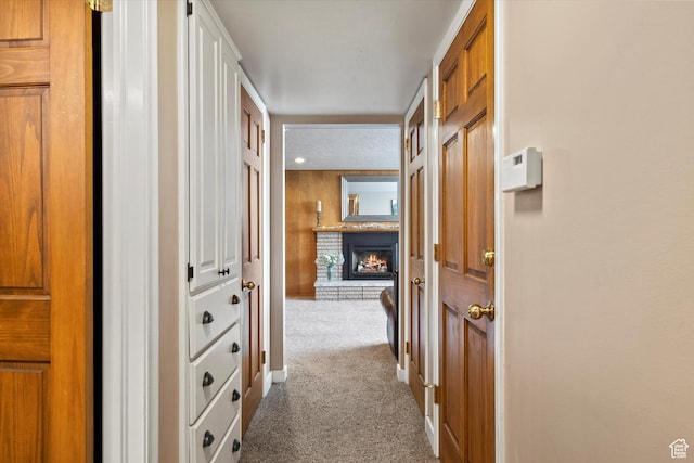 hallway featuring carpet floors and baseboards