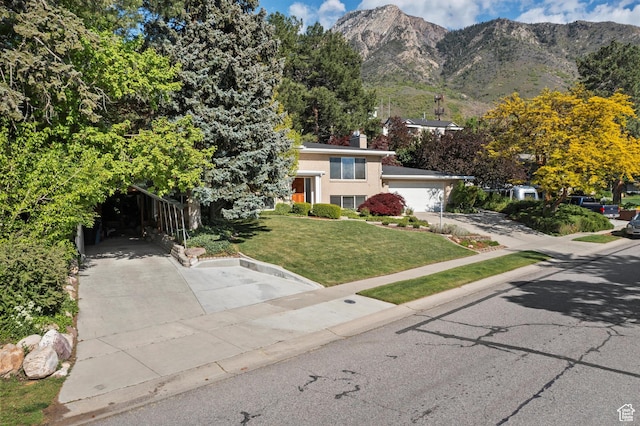 view of front of house featuring a front yard, a mountain view, and a chimney