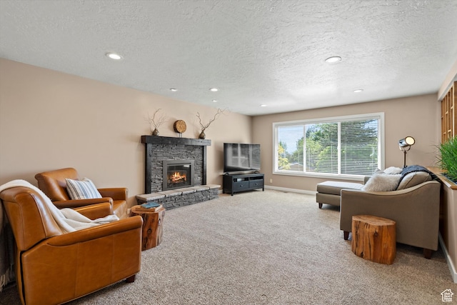 living room featuring carpet floors, a textured ceiling, a fireplace, recessed lighting, and baseboards