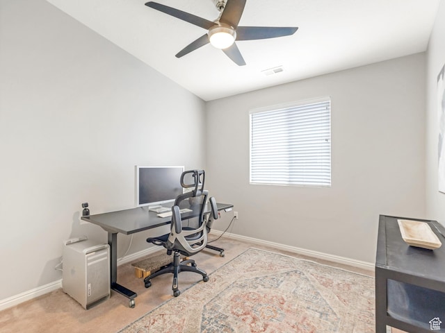 carpeted office featuring a ceiling fan and baseboards