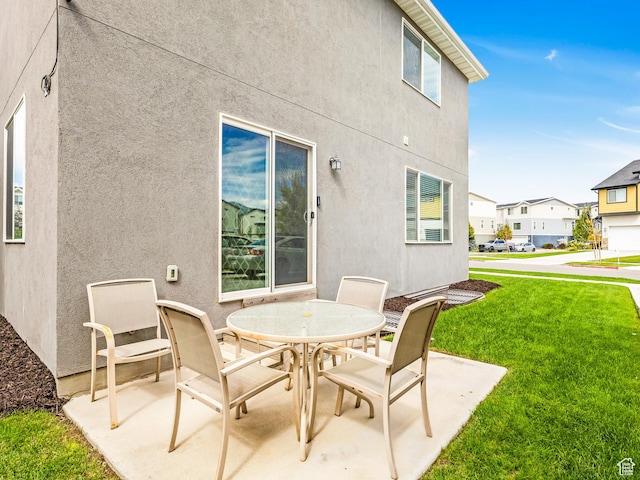 view of patio featuring outdoor dining space and a residential view