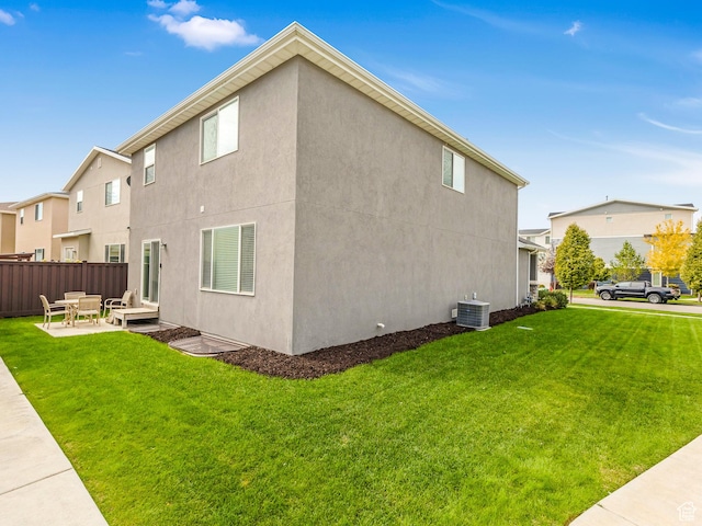 view of side of home with central AC unit, a patio, and stucco siding