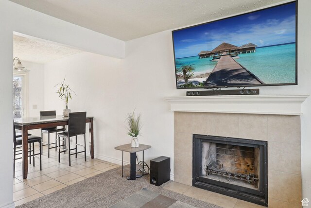 4372 S Wildrose Dr W, West Valley City, UT 84120 - living area featuring tile patterned floors, a fireplace, and a textured ceiling
