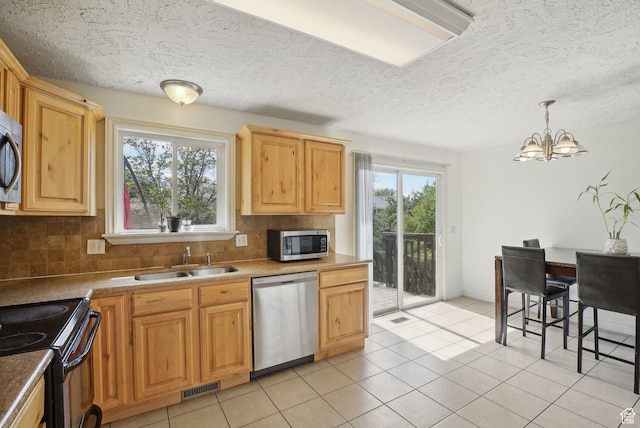 4372 S Wildrose Dr W, West Valley City, UT 84120 - kitchen with appliances with stainless steel finishes, a sink, decorative backsplash, a chandelier, and a textured ceiling