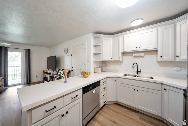 317 S 1000 W Unit 104, Pleasant Grove, UT 84062 - kitchen with dishwasher, a peninsula, a sink, light wood finished floors, and open floor plan
