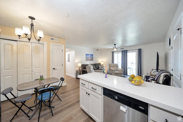317 S 1000 W Unit 104, Pleasant Grove, UT 84062 - kitchen featuring stainless steel dishwasher, open floor plan, white cabinetry, light countertops, and a textured ceiling