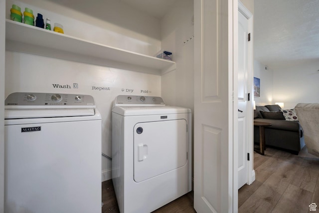 317 S 1000 W Unit 104, Pleasant Grove, UT 84062 - clothes washing area with washer and dryer and wood finished floors