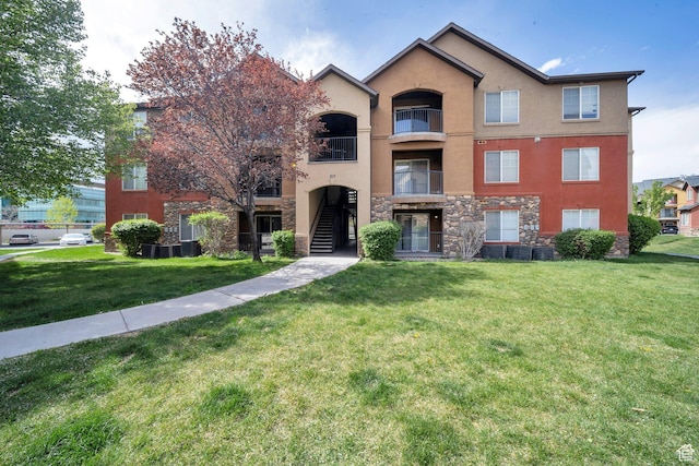 317 S 1000 W Unit 104, Pleasant Grove, UT 84062 - view of front of home with stone siding, stucco siding, and a front lawn