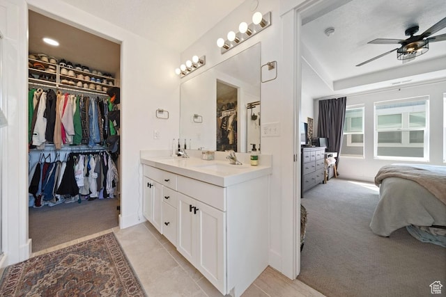3850 W Kinglassie Ln, Taylorsville, UT 84129 - bathroom featuring ceiling fan, a spacious closet, double vanity, ensuite bathroom, and tile patterned flooring