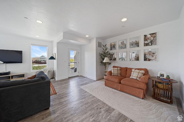 3850 W Kinglassie Ln, Taylorsville, UT 84129 - living area with wood finished floors, recessed lighting, and baseboards