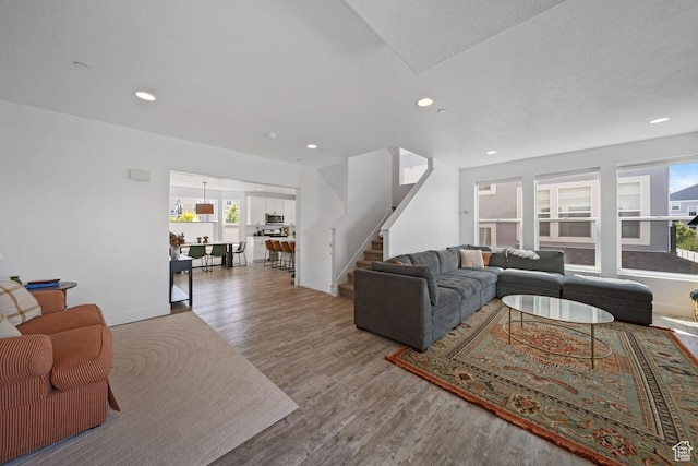 3850 W Kinglassie Ln, Taylorsville, UT 84129 - living room with stairs, wood finished floors, recessed lighting, and baseboards