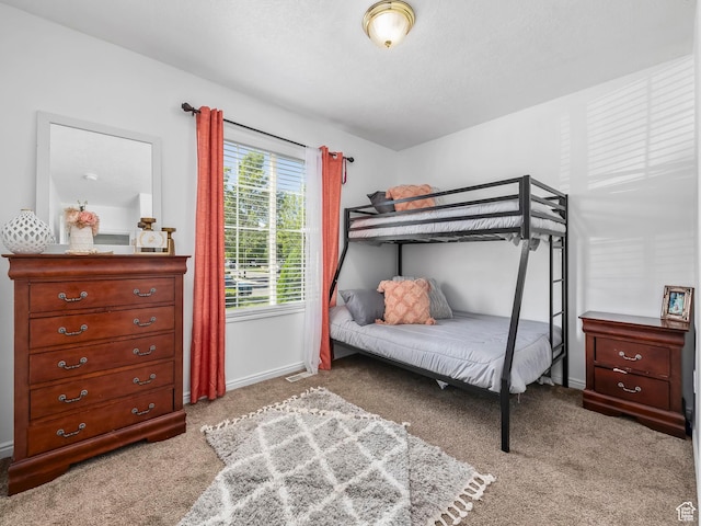carpeted bedroom with baseboards