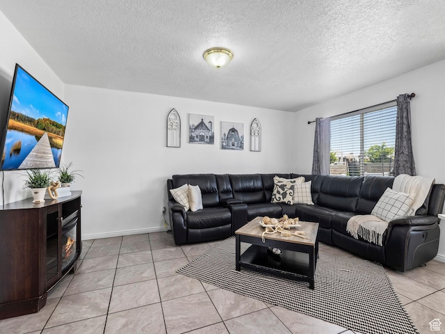 living room featuring light tile patterned flooring and a textured ceiling