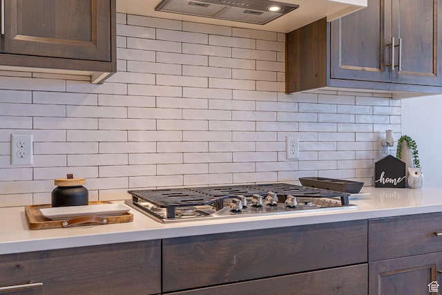 kitchen with light countertops, backsplash, custom exhaust hood, and dark brown cabinetry