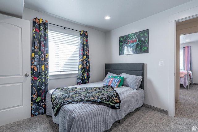 carpeted bedroom with recessed lighting