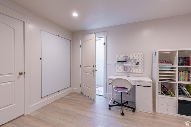 office space with light wood-style floors, recessed lighting, and baseboards
