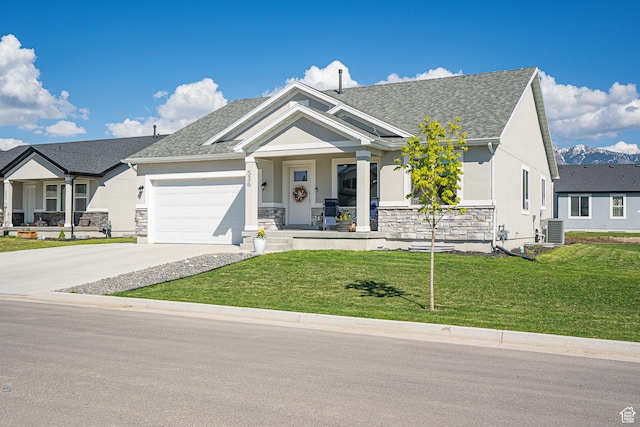 craftsman-style house with a porch, stucco siding, central AC unit, a front yard, and an attached garage