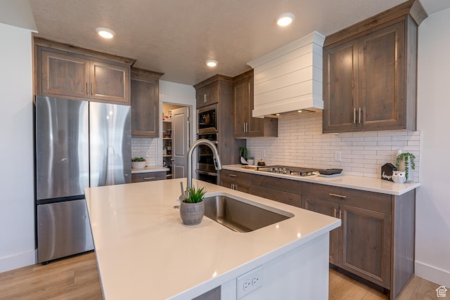 kitchen with appliances with stainless steel finishes, baseboards, custom exhaust hood, light wood-style flooring, and recessed lighting