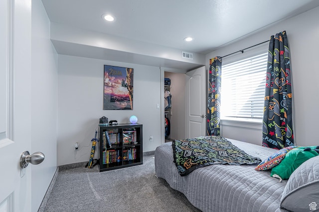 bedroom featuring carpet, baseboards, a spacious closet, and recessed lighting