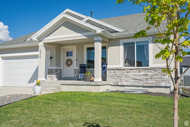 view of front facade featuring stone siding, covered porch, an attached garage, stucco siding, and a front lawn