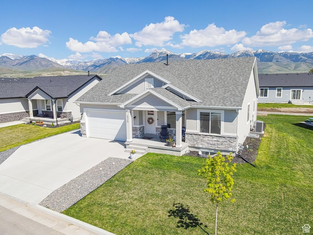 view of front of house featuring a porch, stucco siding, a mountain view, and stone siding