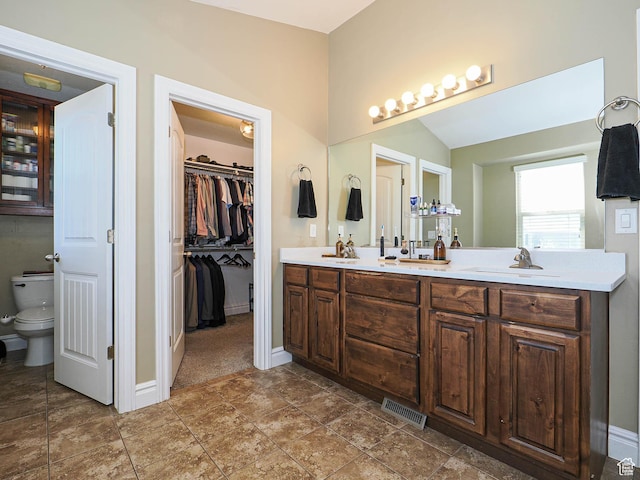 879 W Saddlebrook Dr, Kaysville, UT 84037 - bathroom with double vanity, baseboards, toilet, a spacious closet, and lofted ceiling