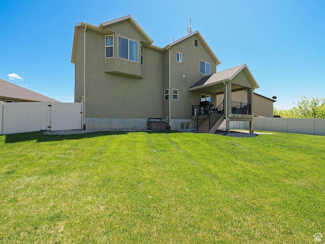 879 W Saddlebrook Dr, Kaysville, UT 84037 - rear view of property featuring stairway, a gate, and stucco siding