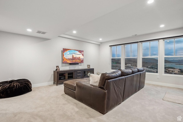 living room featuring light carpet, recessed lighting, and baseboards