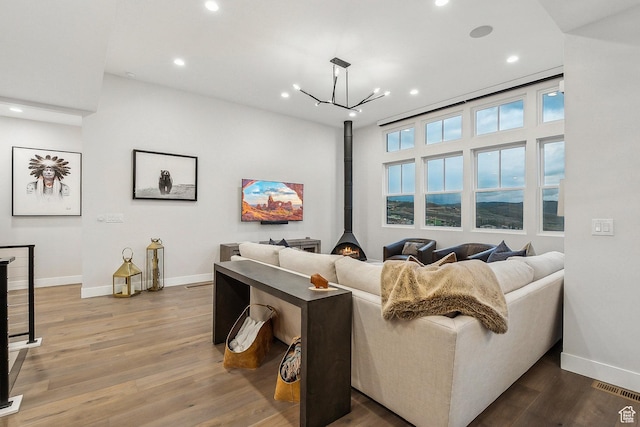 cinema featuring baseboards, recessed lighting, wood finished floors, and a chandelier