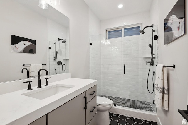 bathroom featuring toilet, a shower stall, vanity, tile patterned floors, and recessed lighting