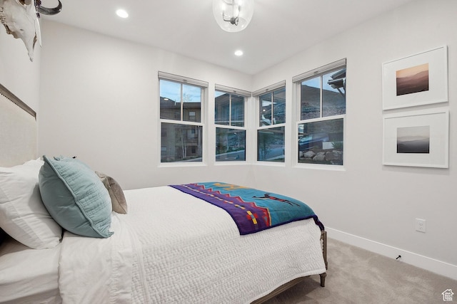 carpeted bedroom with baseboards, recessed lighting, and multiple windows
