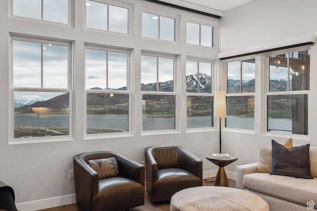 sunroom / solarium featuring a water view