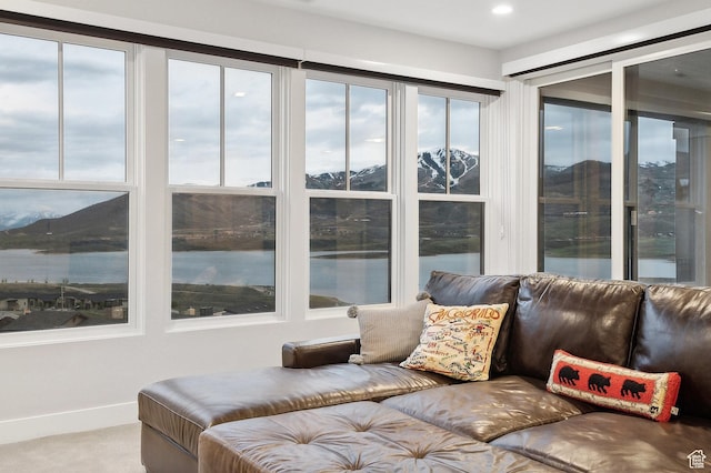 sunroom / solarium featuring a water view