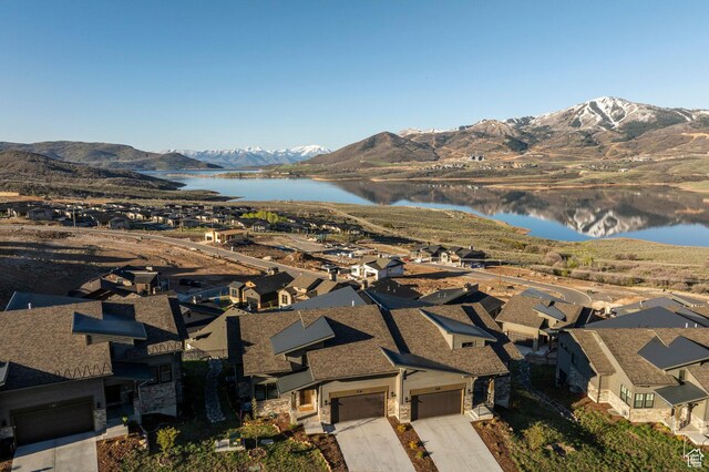 view of property location with a water and mountain view and nearby suburban area