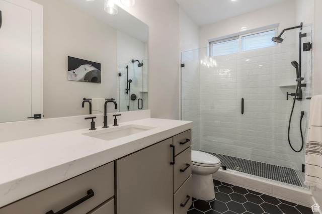 full bathroom with a stall shower, tile patterned floors, vanity, and toilet