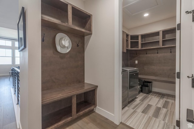 mudroom with washing machine and clothes dryer, attic access, wood finished floors, baseboards, and recessed lighting