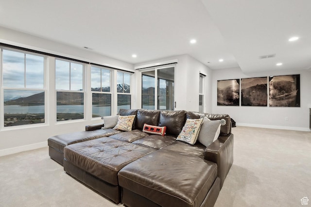 living room featuring light carpet, baseboards, and recessed lighting