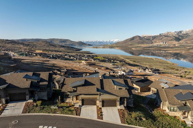 aerial perspective of suburban area featuring a water and mountain view