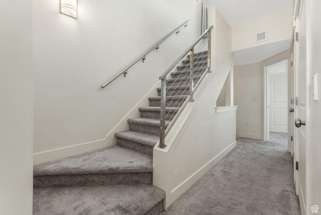 staircase with carpet and baseboards