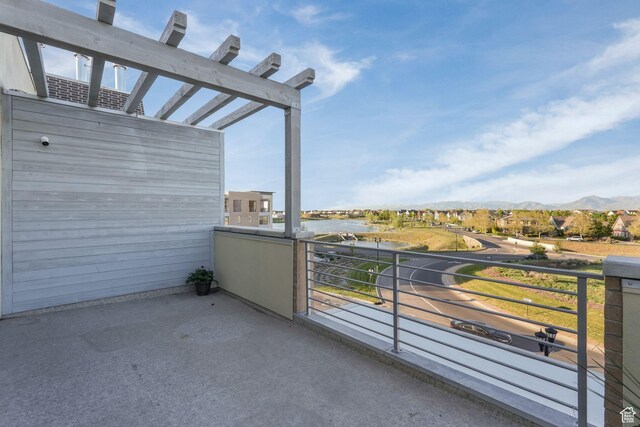 balcony with a water and mountain view