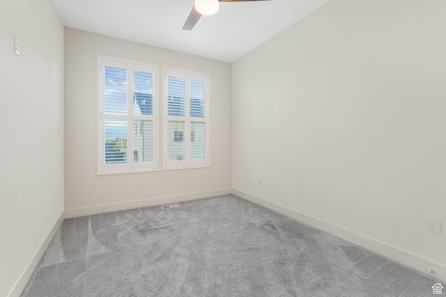 empty room featuring carpet floors, ceiling fan, and baseboards
