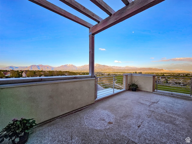 balcony featuring a mountain view and a pergola