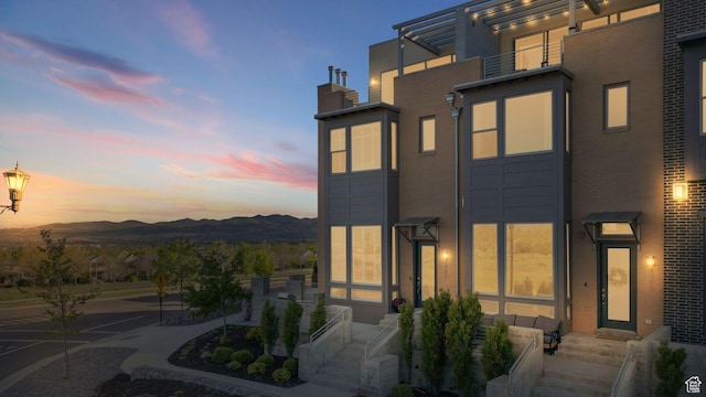 4491 W Daybreak Rim Way S, South Jordan, UT 84009 - back of house with a mountain view and a chimney