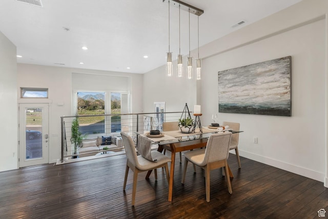 dining room with hardwood / wood-style flooring, recessed lighting, and baseboards
