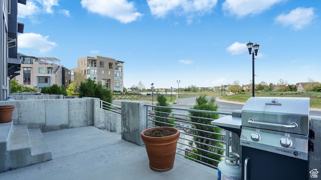 view of patio / terrace featuring grilling area, a residential view, and a balcony