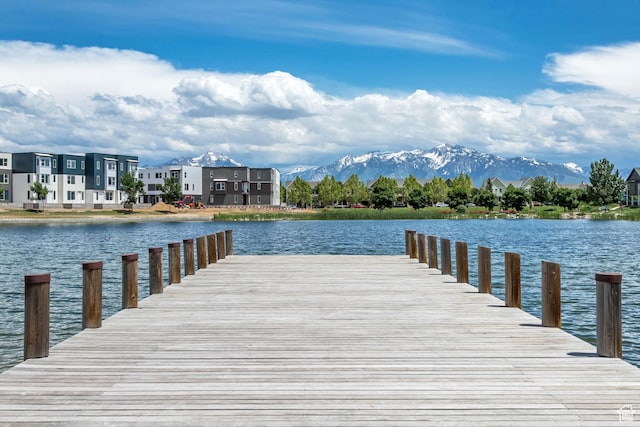 dock area with a water and mountain view and a residential view