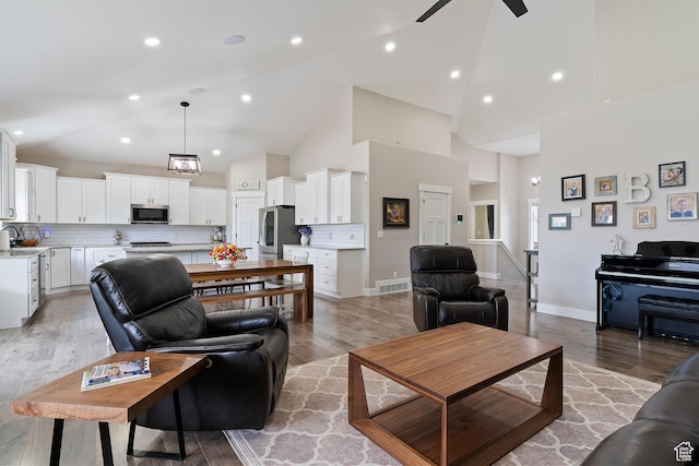 2685 N 850 E, North Ogden, UT 84414 - living room featuring ceiling fan, high vaulted ceiling, light wood finished floors, and recessed lighting