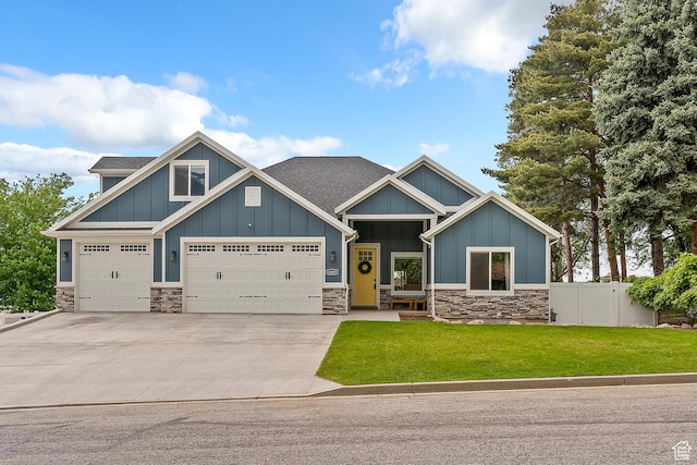 2685 N 850 E, North Ogden, UT 84414 - craftsman-style house with board and batten siding, stone siding, driveway, an attached garage, and a shingled roof