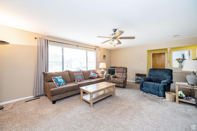 living room with carpet floors, ceiling fan, and baseboards